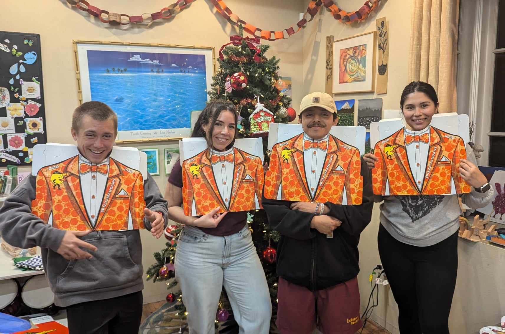 Staff wearing PIZZAMAN tuxedos